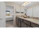 Double vanity bathroom with granite countertops and shower at 2428 Dubai St, Kissimmee, FL 34747
