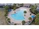 Community pool with expansive deck and lounge chairs at 2428 Dubai St, Kissimmee, FL 34747
