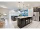 Open concept kitchen with large island and stainless steel appliances at 2428 Dubai St, Kissimmee, FL 34747
