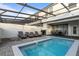 Private screened pool with lounge chairs and patio furniture at 2428 Dubai St, Kissimmee, FL 34747