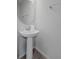 Small powder room with pedestal sink and large mirror at 2428 Dubai St, Kissimmee, FL 34747