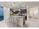 Modern kitchen with stainless steel appliances and an island with seating at 2428 Dubai St, Kissimmee, FL 34747