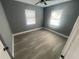 Bright bedroom with grey walls and wood-look flooring at 830 Wooden Blvd, Orlando, FL 32805