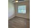Well-lit bedroom with wood-look flooring and a window at 830 Wooden Blvd, Orlando, FL 32805