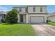 Two-story house with gray siding, double car garage, and manicured lawn at 2548 Lyndscape St, Orlando, FL 32833