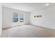 Bright bedroom with two windows and neutral colored carpet at 2548 Lyndscape St, Orlando, FL 32833