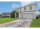 Two-story house with gray siding, double car garage, and manicured lawn at 2548 Lyndscape St, Orlando, FL 32833