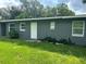 Updated home exterior with gray siding and green lawn at 830 Wooden Blvd, Orlando, FL 32805