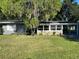 House exterior with gray siding, stone accents, and carport at 830 Wooden Blvd, Orlando, FL 32805