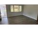 Living room with new flooring and access to sunroom at 830 Wooden Blvd, Orlando, FL 32805