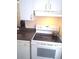 White appliances and dark countertops in this well-lit kitchen at 6320 Raleigh St # 604, Orlando, FL 32835