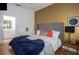 King-size bed, gold accent wall, and nearby bathroom access at 703 Lucaya Loop # 1103, Davenport, FL 33897