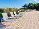Spacious pool deck with lounge chairs and umbrella at 703 Lucaya Loop # 1103, Davenport, FL 33897