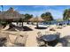 Sandy beach area with hammocks, tables, and thatch umbrellas at 703 Lucaya Loop # 1103, Davenport, FL 33897