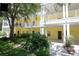Yellow two-story building with walkway and landscaping at 703 Lucaya Loop # 1103, Davenport, FL 33897