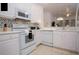 White kitchen with updated appliances and a stylish backsplash at 703 Lucaya Loop # 1103, Davenport, FL 33897
