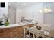 Kitchen with white cabinets, a breakfast bar, and a modern chandelier at 703 Lucaya Loop # 1103, Davenport, FL 33897