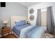 Bedroom with a queen-size bed, blue bedding, and a window with gray curtains at 703 Lucaya Loop # 1103, Davenport, FL 33897