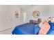 Cozy bedroom with a blue double bed and stylish decor at 3887 Malawi Trl, Saint Cloud, FL 34772