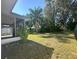 Spacious backyard with lush lawn and mature trees at 573 Hummingbird Ct, Kissimmee, FL 34759