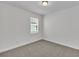 Simple bedroom with grey carpet and a window with blinds at 3120 Legends Preserve Dr, Daytona Beach, FL 32124