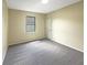 Bright bedroom with carpeted floor, neutral walls, and a window at 15106 Ovation Dr, Winter Garden, FL 34787