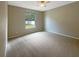 Spacious bedroom with carpeted floor and large window at 15106 Ovation Dr, Winter Garden, FL 34787
