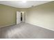 Carpeted bedroom with neutral walls and door to bathroom at 15106 Ovation Dr, Winter Garden, FL 34787