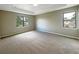 Well-lit bedroom with two windows and neutral walls at 15106 Ovation Dr, Winter Garden, FL 34787