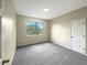 Simple bedroom with gray carpeting, a window, and neutral walls at 15106 Ovation Dr, Winter Garden, FL 34787