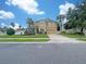 Two-story house, yellow facade, landscaping, and a driveway at 15106 Ovation Dr, Winter Garden, FL 34787