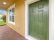 Green front door and brick walkway leading to the entrance at 15106 Ovation Dr, Winter Garden, FL 34787