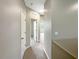 Hallway with carpeted floor and doors to bedrooms at 15106 Ovation Dr, Winter Garden, FL 34787