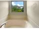 Relaxing bathtub with a view of lush greenery at 15106 Ovation Dr, Winter Garden, FL 34787