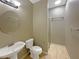 Bathroom with shower, toilet, and pedestal sink at 15106 Ovation Dr, Winter Garden, FL 34787