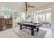 Game room features a pool table, stylish decor, and access to the outdoor patio at 16828 Vinci Way, Montverde, FL 34756