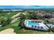 Aerial view of community pool and clubhouse near golf course at 16828 Vinci Way, Montverde, FL 34756