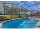Screened-in pool and spa with backyard view at 4424 Kaipo Rd, Davenport, FL 33897