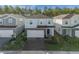 Two-story house with gray and white exterior and two-car garage at 4424 Kaipo Rd, Davenport, FL 33897