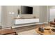 Living area with wood-look floors and built-in media console at 4424 Kaipo Rd, Davenport, FL 33897