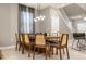 Bright dining room with a modern wooden table and six chairs at 4424 Kaipo Rd, Davenport, FL 33897
