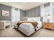 Main bedroom with a king-size bed and a cozy armchair at 4424 Kaipo Rd, Davenport, FL 33897