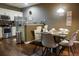 Modern kitchen with stainless steel appliances and granite countertops, adjacent to dining area at 3211 Gold Ln, Kissimmee, FL 34747