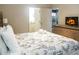 Spacious main bedroom with king-size bed and fireplace TV at 3211 Gold Ln, Kissimmee, FL 34747