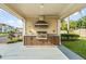 Outdoor kitchen with grill and seating area at 3211 Gold Ln, Kissimmee, FL 34747