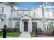 Two-story home with neutral siding, brown door, and landscaping at 3211 Gold Ln, Kissimmee, FL 34747