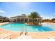 Community pool with palm trees and lounge chairs at 3211 Gold Ln, Kissimmee, FL 34747