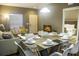 Dining area with glass table, six chairs and open concept kitchen at 3211 Gold Ln, Kissimmee, FL 34747
