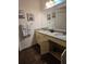 Double vanity bathroom with granite countertop and beige cabinets at 3211 Gold Ln, Kissimmee, FL 34747