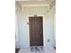 Brown front door with Mickey Mouse welcome mat at 3211 Gold Ln, Kissimmee, FL 34747